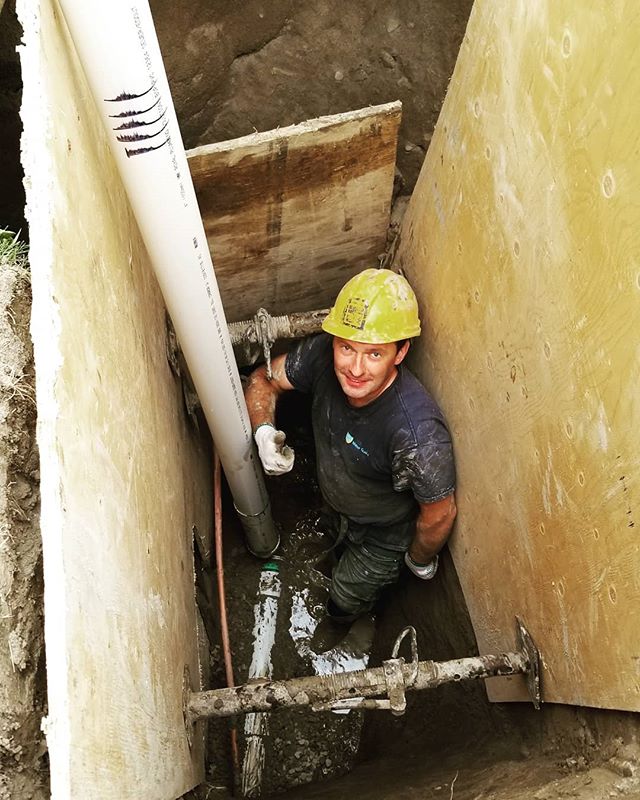 man in a trench repairing water line