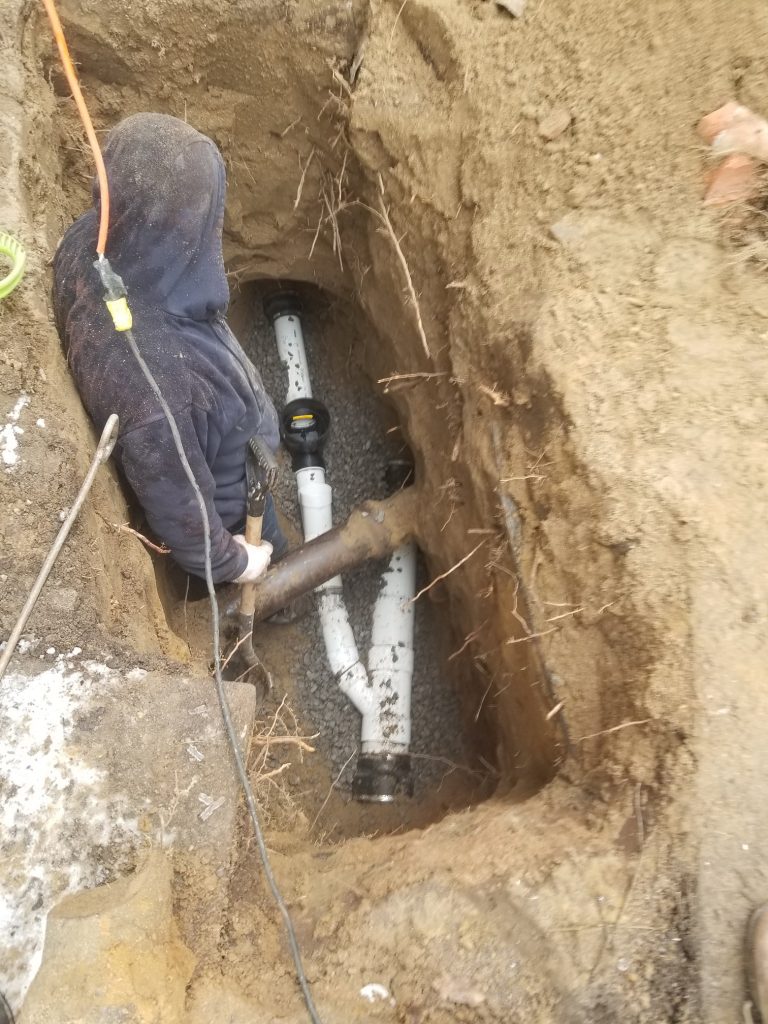 Plumber is installing a backwater valve